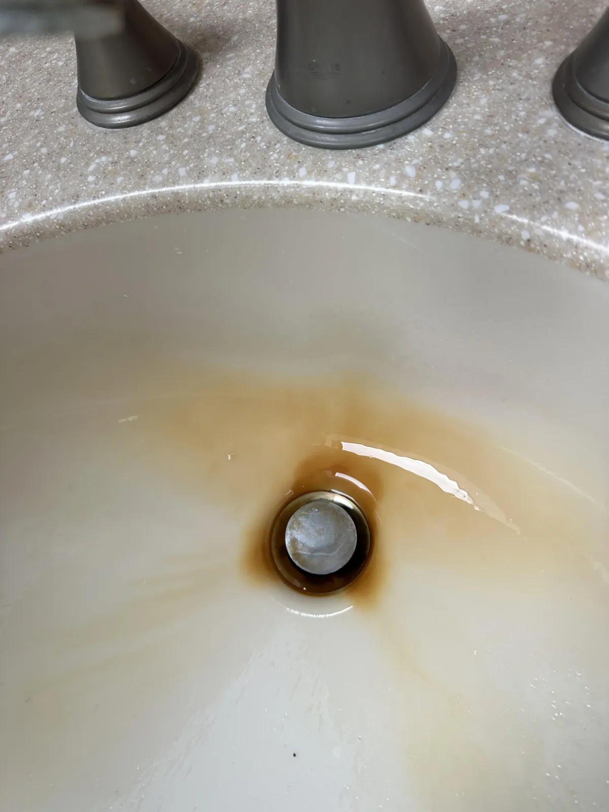 Bathroom sink and fixtures before cleaning